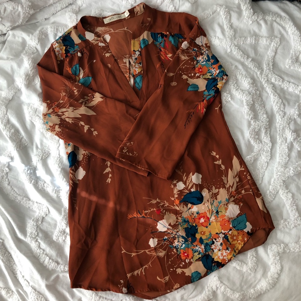 Orangey blouse with flower Pattern.